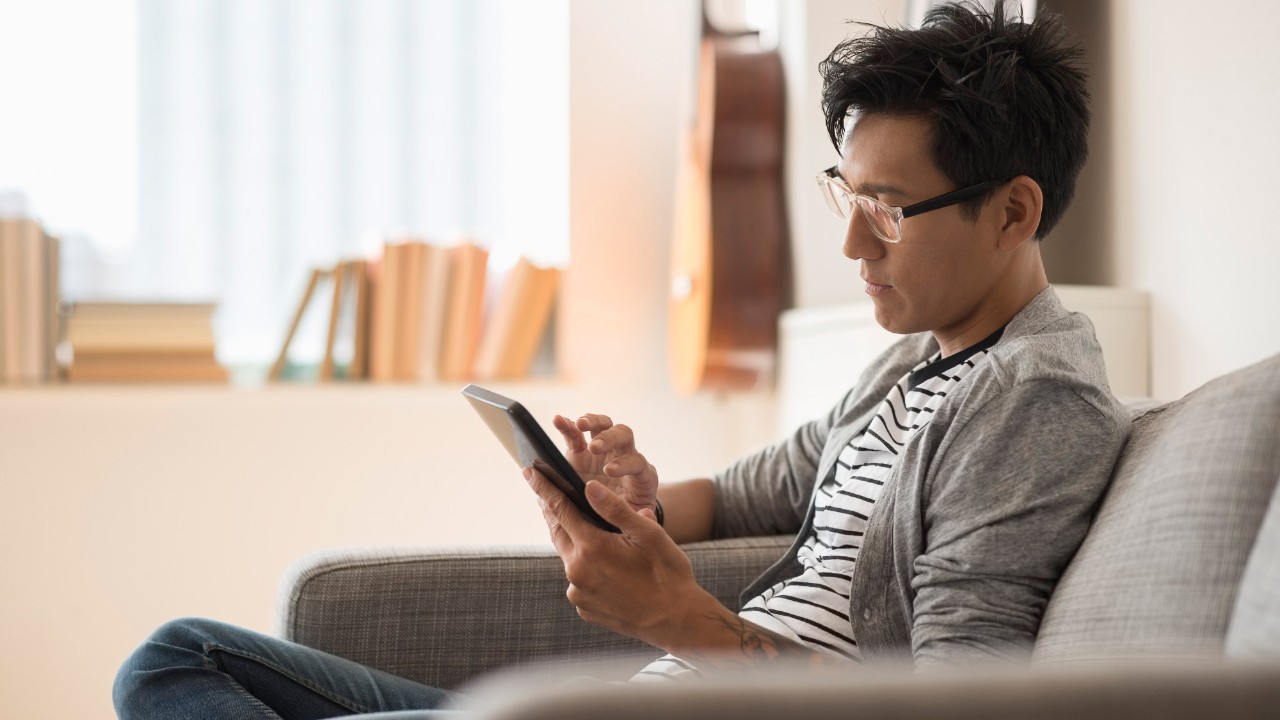 A man is using a tablet; image used for HSBC Malaysia Amanah Online banking