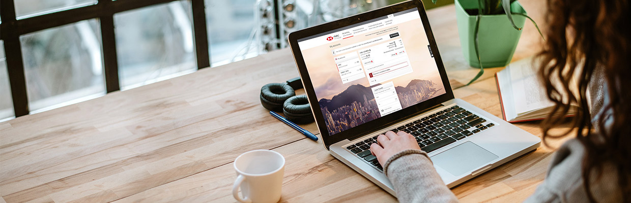 A woman is using a laptop to check her HSBC account; image used for HSBC Malaysia Amanah ways to bank page.