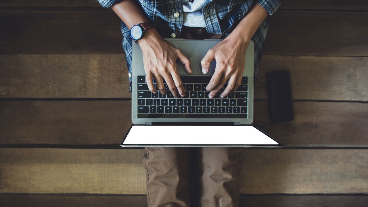 Man in casual wear typing on a laptop; image used for HSBC Amanah Fusion ‘How SME owners protect the business from phishing’ article.