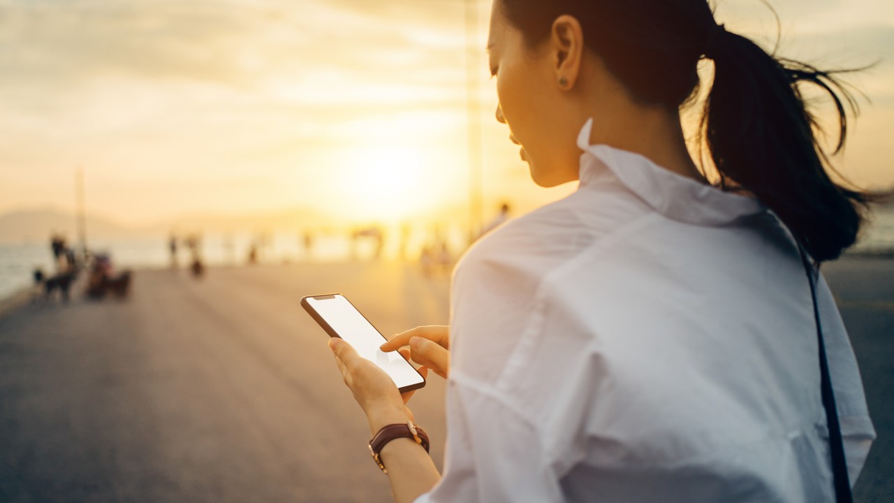 A businesswoman using online banking service on her mobile; image used for HSBCnet upgrade for small business page - faster banking section.