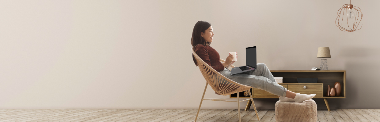 A female entrepreneur using digital banking on a chair; image used for HSBCnet upgrade for small business page.