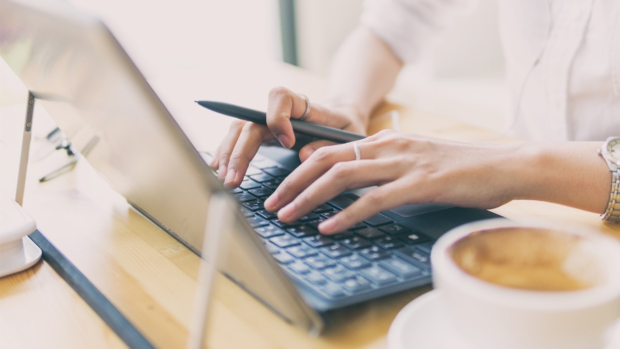 Both hands are typing; image used for HSBC Malaysia Amanah Safe internet banking page.