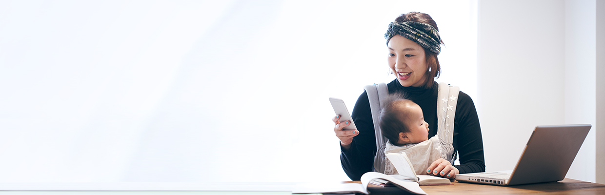 Mother with baby working at home; image used for HSBC Malaysia Amanah Remote Engagement Service page