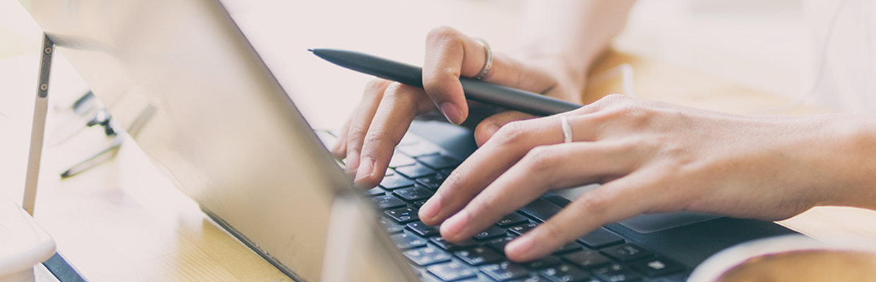 Both hands are typing; image used for HSBC Malaysia Amanah Safe internet banking page.